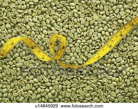 Stock Photo - Green coffee beans and tape measure.. Fotosearch