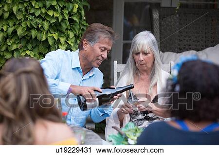 Guests enjoying and celebrating at garden party View Large Photo Image Stock Image - Guests enjoying and celebrating at garden party. Fotosearch