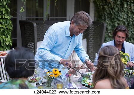 Guests enjoying and celebrating at garden party View Large Photo Image Stock Image - Guests enjoying and celebrating at garden party. Fotosearch