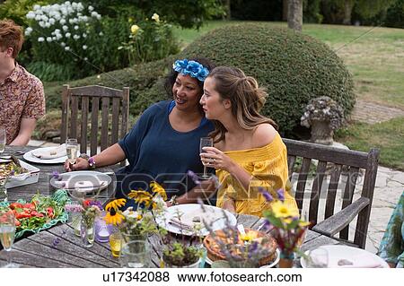 Guests enjoying and celebrating at garden party View Large Photo Image Stock Photo - Guests enjoying and celebrating at garden party. Fotosearch