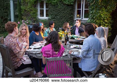 Stock Photograph - Guests enjoying and celebrating at garden party. Fotosearch