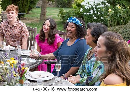 Guests enjoying and celebrating at garden party View Large Photo Image Stock Photograph - Guests enjoying and celebrating at garden party. Fotosearch