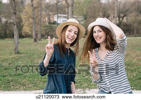 Stock Image - Happy girlfriends in park. Fotosearch