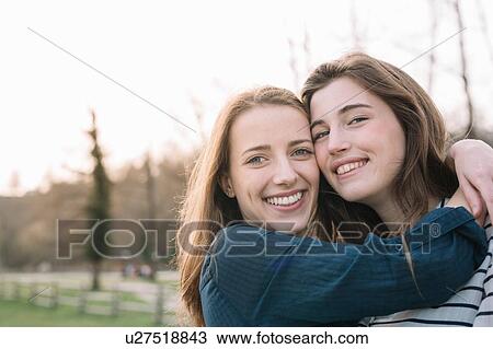 Stock Image - Happy girlfriends in park. Fotosearch