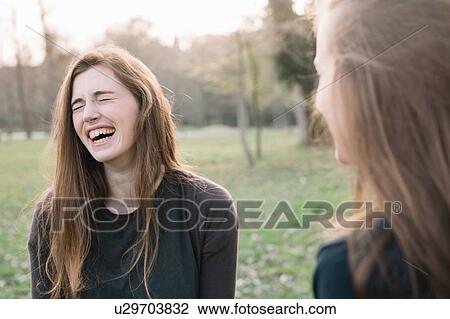 Stock Image - Happy girlfriends in park. Fotosearch