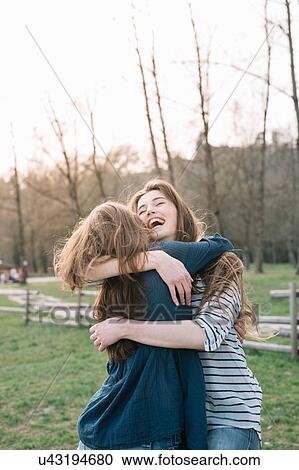Stock Image - Happy girlfriends in park. Fotosearch