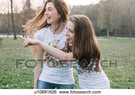 Stock Photograph - Happy girlfriends in park. Fotosearch