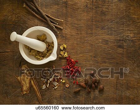 Stock Image - Herbs and equipment used for alternative medicine.. Fotosearch
