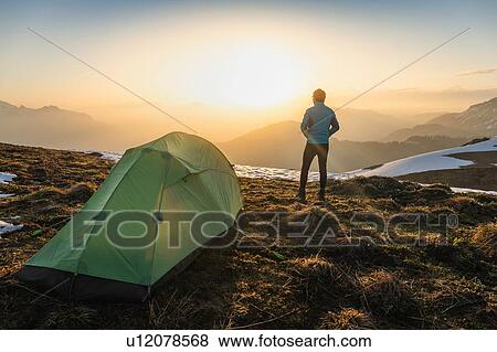 Stock Photo - Hiker camping on French Alps, Parc naturel rgional du Massif des Bauges, Chatelard-en-Bauges, Rhone-Alpes, France. Fotosearch