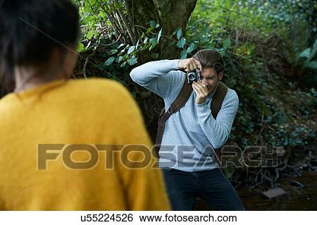 Stock Photograph - Hiker couple taking photograph at walk. Fotosearch