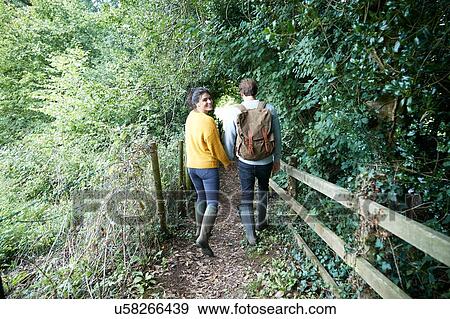 Hiker couple walking in countryside View Large Photo Image Stock Photo - Hiker couple walking in countryside. Fotosearch