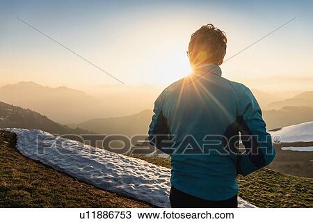 Stock Image - Hiker trekking French Alps, Parc naturel rgional du Massif des Bauges, Chatelard-en-Bauges, Rhone-Alpes, France. Fotosearch
