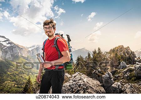 Stock Image - Hiker trekking French Alps, Parc naturel rgional du Massif des Bauges, Chatelard-en-Bauges, Rhone-Alpes, France. Fotosearch