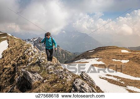 Stock Photo - Hiker trekking French Alps, Parc naturel rgional du Massif des Bauges, Chatelard-en-Bauges, Rhone-Alpes, France. Fotosearch