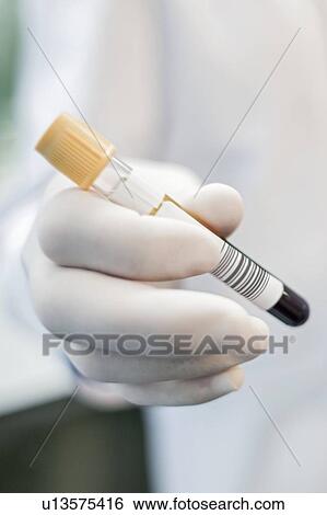 Laboratory assistant holding test tube, close up. View Large Photo Image Stock Photograph - Laboratory assistant holding test tube, close up.. Fotosearch