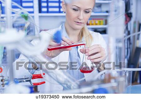 Laboratory assistant with chemical experiment. View Large Photo Image Stock Image - Laboratory assistant with chemical experiment.. Fotosearch