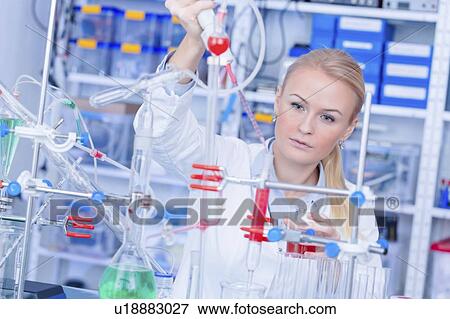 Stock Photo - Laboratory assistant with chemical experiment.. Fotosearch