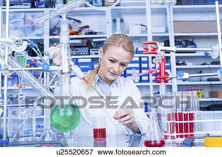 Stock Photo - Laboratory assistant with chemical experiment.. Fotosearch