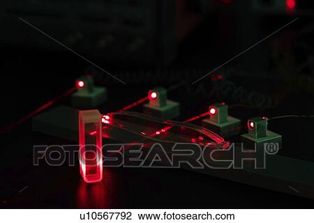 Stock Image - Laser experiment in photonics laboratory.. Fotosearch