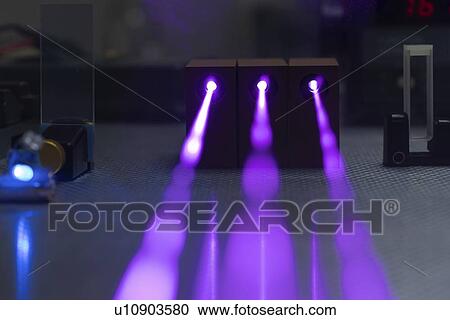Stock Image - Laser experiment in photonics laboratory.. Fotosearch