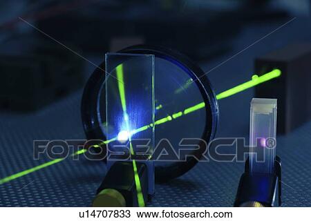 Stock Image - Laser experiment in photonics laboratory.. Fotosearch