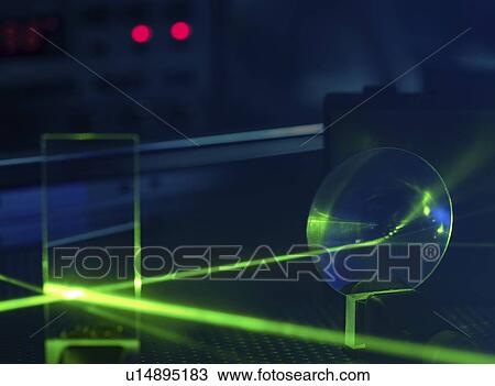 Stock Image - Laser experiment in photonics laboratory.. Fotosearch