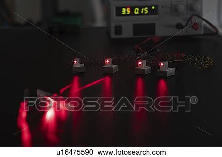 Stock Image - Laser experiment in photonics laboratory.. Fotosearch