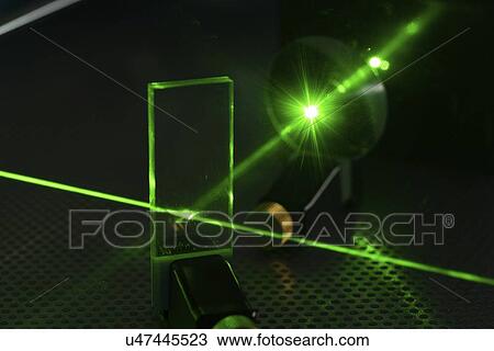 Stock Image - Laser experiment in photonics laboratory.. Fotosearch