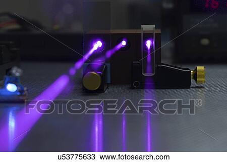 Stock Image - Laser experiment in photonics laboratory.. Fotosearch
