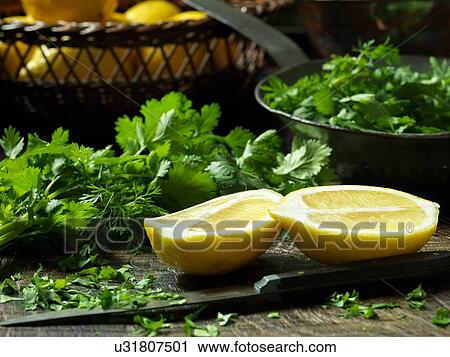 Lemon halves and chopped Parsley View Large Photo Image Stock Image - Lemon halves and chopped Parsley. Fotosearch