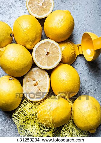 Lemons in grid with squeezer View Large Photo Image Picture - Lemons in grid with squeezer. Fotosearch
