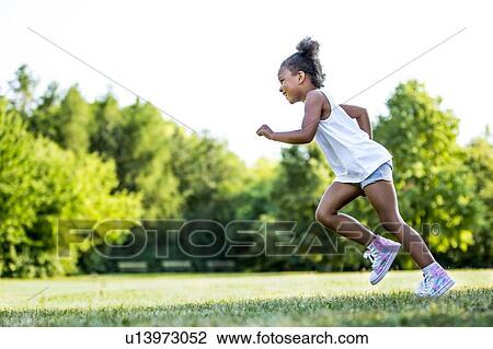 Little girl running in park, smiling. View Large Photo Image Stock Image - Little girl running in park, smiling.. Fotosearch