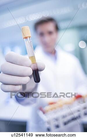 Male laboratory assistant holding test tube. View Large Photo Image Stock Photo - Male laboratory assistant holding test tube.. Fotosearch