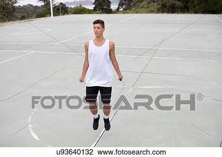 Male teenage basketball player on basketball court skipping View Large Photo Image Stock Image - Male teenage basketball player on basketball court skipping. Fotosearch