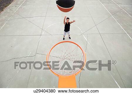 Male teenage basketball player throwing ball toward basketball hoop, high angle view View Large Photo Image Stock Image - Male teenage basketball player throwing ball toward basketball hoop, high angle view. Fotosearch