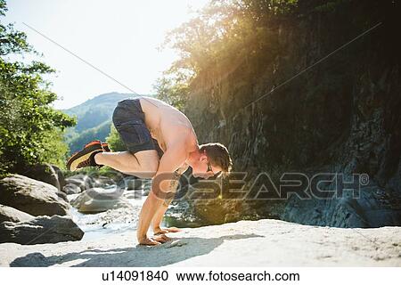 Man balancing on hands by stream, Arezzo, Toscana, Italy View Large Photo Image Stock Image - Man balancing on hands by stream, Arezzo, Toscana, Italy. Fotosearch