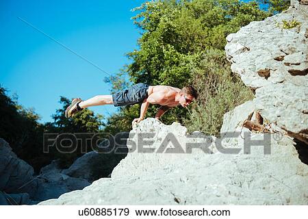 Man balancing on hands by stream, Arezzo, Toscana, Italy View Large Photo Image Stock Photo - Man balancing on hands by stream, Arezzo, Toscana, Italy. Fotosearch