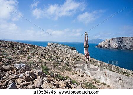 Man doing handstand on hilltop, Iglesias, Sardinia, Italy View Large Photo Image Stock Photography - Man doing handstand on hilltop, Iglesias, Sardinia, Italy. Fotosearch