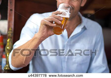 Stock Photo - Man drinking beer. Fotosearch