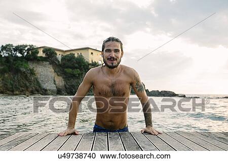 Man emerging on pier by sea, Livorno, Italy View Large Photo Image Stock Image - Man emerging on pier by sea, Livorno, Italy. Fotosearch