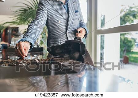 Stock Photo - Man giving treat to dog. Fotosearch
