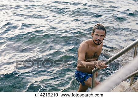 Man going up steps from sea View Large Photo Image Stock Image - Man going up steps from sea. Fotosearch