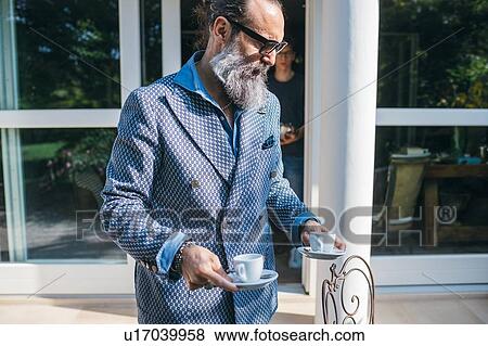 Man having coffee on patio View Large Photo Image Stock Photo - Man having coffee on patio. Fotosearch