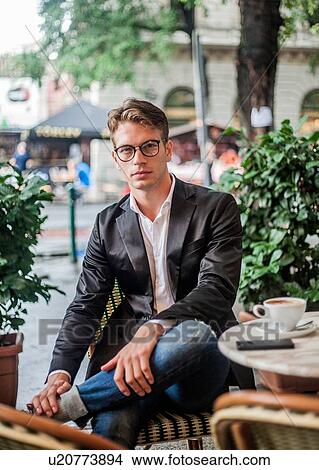 Picture - Man having morning coffee at outdoor cafe, Budapest, Hungary. Fotosearch