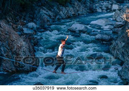 Man highlining above river, Truckee, California, USA View Large Photo Image Stock Photo - Man highlining above river, Truckee, California, USA. Fotosearch