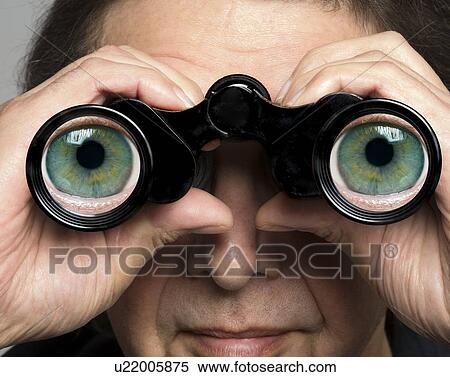 Stock Photography - Man holding binoculars with eyes on lenses. Fotosearch