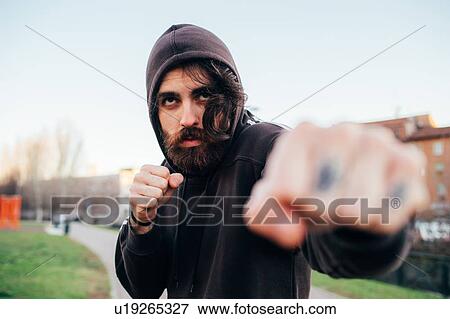 Stock Photo - Man in hoodie in fighting pose. Fotosearch