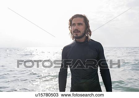 Man in wetsuit by sea View Large Photo Image Stock Image - Man in wetsuit by sea. Fotosearch