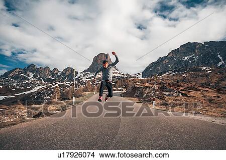 Picture - Man jumping on road, Francenigo, Veneto, Italy. Fotosearch