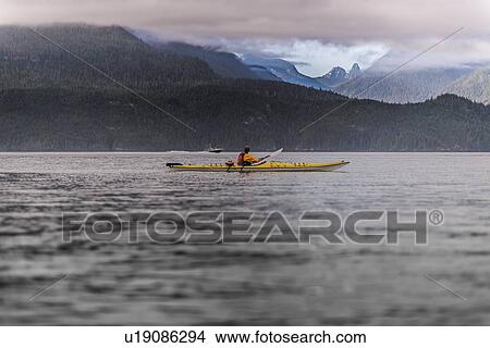 Man kayaking in lake, Johnstone Strait, Telegraph Cove, Canada View Large Photo Image Picture - Man kayaking in lake, Johnstone Strait, Telegraph Cove, Canada. Fotosearch
